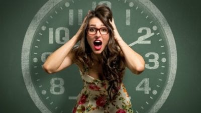 girl in front of clock freaking out because she's late