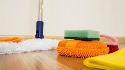 cleaning supplies strewn about on hardwood floor