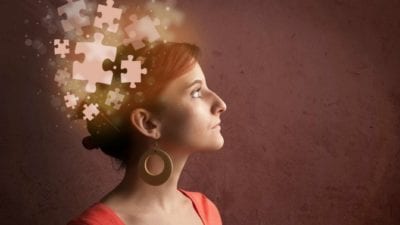 Woman with brain puzzle staying in the moment