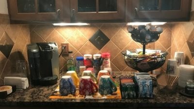 clean countertops with coffee pot and toppings