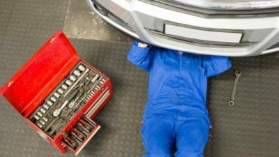 Mechanic under car is like scrubbing floors on hands and knees