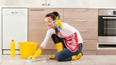 scrubbing floors on hands and knees girl giving thumbs up
