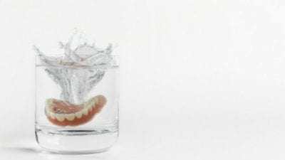 Habits dentures in a cup of water