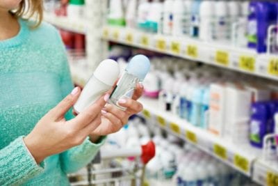 Woman choosing antiperspirant or deodorant