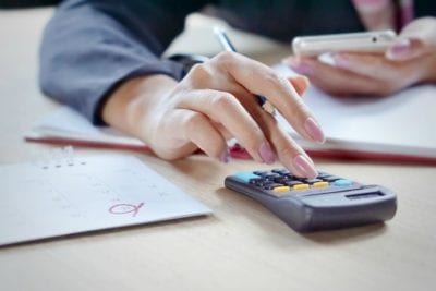 Woman hand with calculator client doesn't pay
