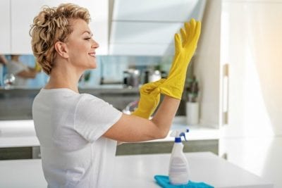 MLM's and House Cleaners, Woman Smiling Putting on Cleaning Gloves