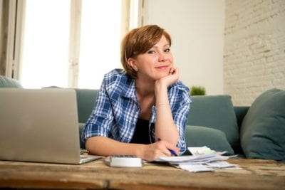 Go Full Time, Smiling Woman Going Through Her Bills