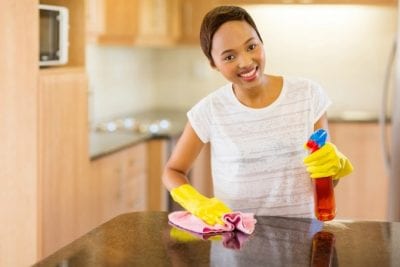 Price Your Service, Happy Woman Cleaning Kitchen