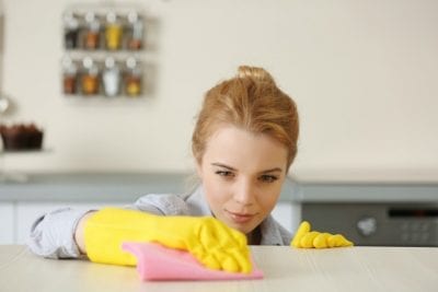 Obsessive Compulsive Cleaners, Woman Cleaning Spot on Counter