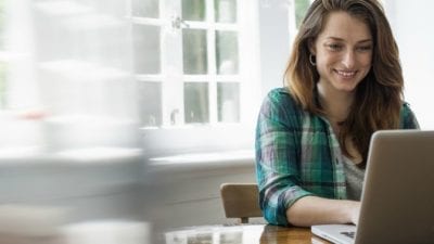 Tax Tips Woman smiling at computer