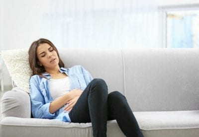 Who Pays When Stuff Breaks, Woman Not Feeling Well Sitting on Couch
