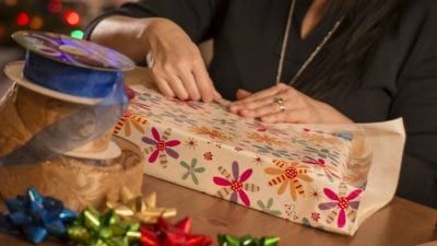 Suspend House Cleaning Service woman wrapping christmas presents