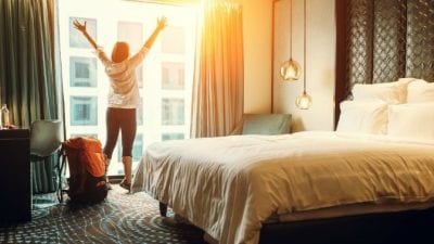 Guest Room Clean-Up woman standing in hotel room