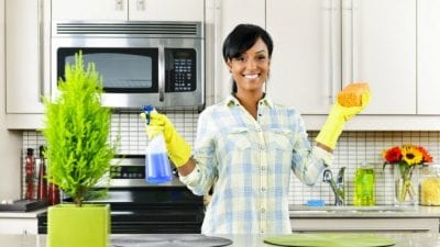No Money, No Car house cleaner in kitchen holding cleaning supplies