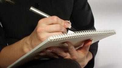 Cruelty-Free Cleaning Products woman writing notes on clipboard