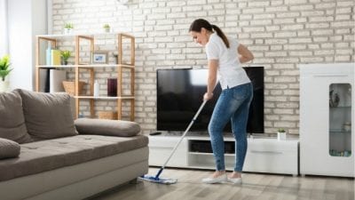 How Much to Clean 5 Rooms woman mopping in living room