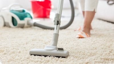 Who Does the Daily Chores woman vacuuming carpet
