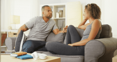 Stay Safe When Cleaning Solo, Man and Woman Talking on Couch