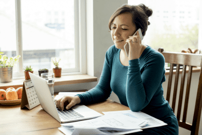 Stay Safe When Cleaning Solo, Woman Talking on Phone at Desk