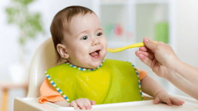 Tips for New Moms baby being fed in high chair