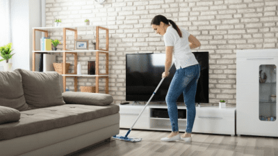 Tips for New Moms woman cleaning living room with mop