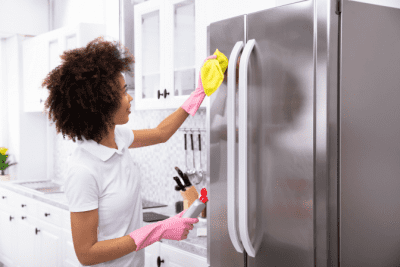 Base Rate or Charge More for a Deep Clean, Woman Wiping Refrigerator