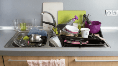 Customers Try to Get a Free Cleaning piles of dirty dishes in kitchen sink
