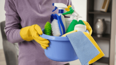 Maid Steals Clients Time woman holding housecleaning supplies at home