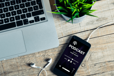 Should Your Cleaning Buisness Have a Podcast, Podcast on Phone on Desk