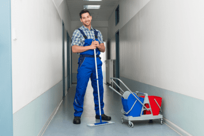 Cleaning Commercial Toilets, Man Cleaning Hallway in Building