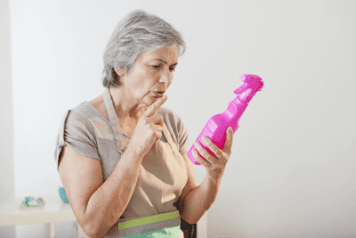 Disinfect as a Professional House Cleaner, Woman Reading Bottle