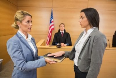 Fire My Cleaning Employee, Woman in Court with Hand on Bible