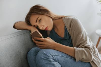 Depressed and Can't Cope with Cleaning, Depressed Woman Looks at Phone