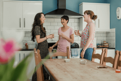 I Hired My Friend to Clean My House, Three Women Standing and Talking in Kitchen