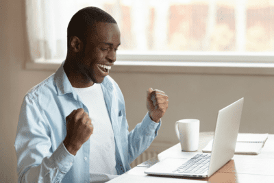 Start a Cleaning Company in Another Country, Excited Man Looking at Laptop