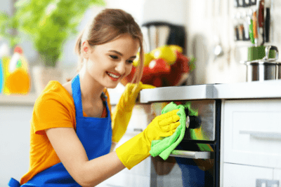Thinking About Selling Your Cleaning Business, Woman Cleaning Oven