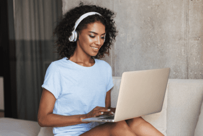 Business Burnout, Woman on Computer with Headphones