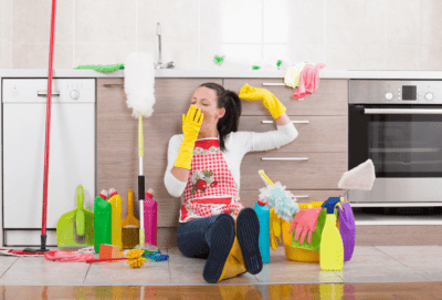 How to Charge for Cleaning Jobs, Tired House Cleaner with Mop and Cleaning Supplies