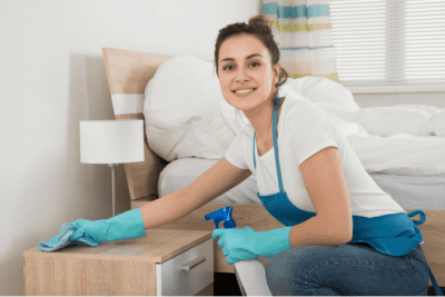How to Charge for Cleaning Jobs, Woman Cleaning Nightstand