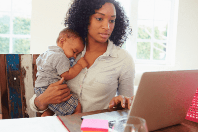 How to Get Cleaning Clients Online, Woman Holding Baby Looks at Computer