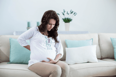 Cleaning While Pregnant, Pregnant Woman Holds Sore Back