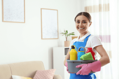 Why Uniforms Work, Happy House Cleaner Holding Cleaning Supplies in Caddy