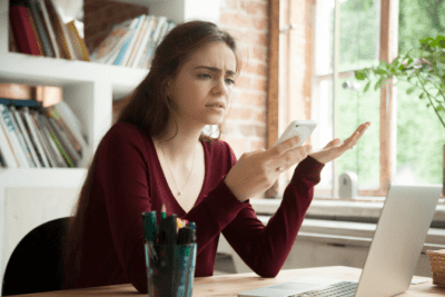 Will You Make a Hiring Mistake, Woman Upset Looking at Phone