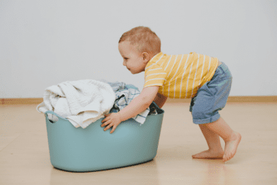 Big Sister's Secret to Cleaning, Little Boy With Laundry Basket of Clothes