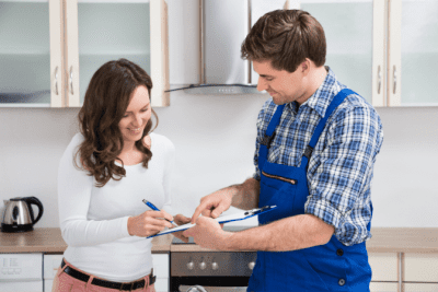 Dissatisfied Customer, Man Holding Clipboard With Woman in Kitchen
