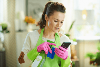 My Own Cleaning Software, House Cleaner Looks at Phone