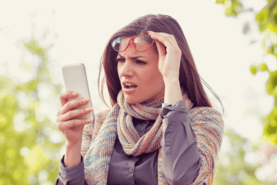 Smartphone Ready, Confused Woman Looking at Phone
