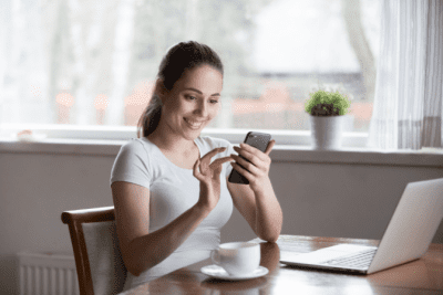 Smartphone Ready, Happy Woman Looks at Phone